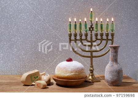 Jewish holiday Hanukkah background with menorah and dreidel with letters Gimel and Nun. Jewish holiday Hanukkah background with menorah and dreidel with letters Gimel and Nun. 97159698