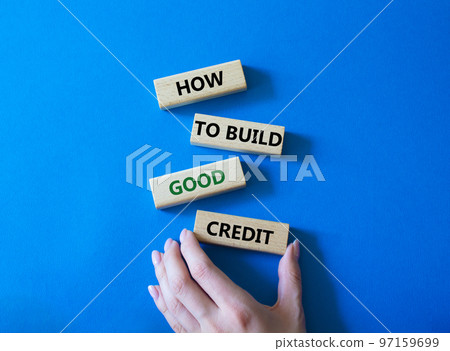 How to build good credit symbol. Concept words How to build good credit on wooden blocks. Beautiful blue background. Businessman hand. Business and How to build good credit concept. Copy space. How to build good credit symbol. Concept words How to build good credit on wooden blocks. Beautiful blue background. Businessman hand. Business and How to build good credit concept. Copy space. 97159699