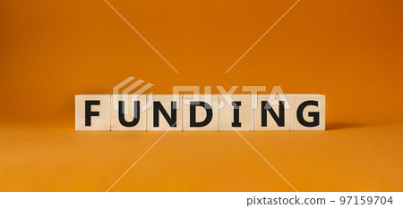 Funding symbol. Concept word Funding on wooden cubes. Beautiful orange background. Business and Funding concept. Copy space. Funding symbol. Concept word Funding on wooden cubes. Beautiful orange background. Business and Funding concept. Copy space. 97159704