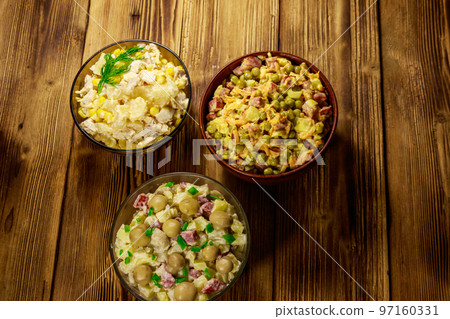 Set of festive mayonnaise salads on wooden table 97160331