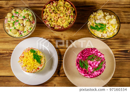 Set of festive mayonnaise salads on wooden table. Top view Set of festive mayonnaise salads on wooden table. Top view 97160334