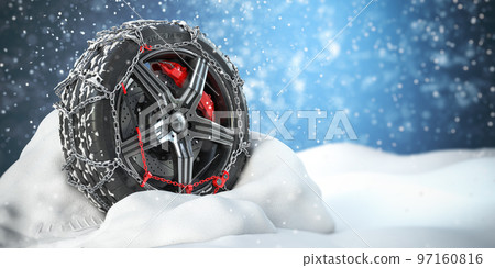 Car wheel with winter tire and snow chain in snow. 97160816