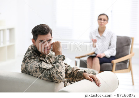 Male military officer having appointment with psychotherapist in office Male military officer having appointment with psychotherapist in office 97160872