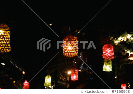 Christmas lights hanging along the street at night Christmas lights hanging along the street at night 97160908