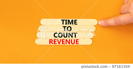 Time to count revenue symbol. Concept word Time to count revenue on wooden sticks. Businessman hand. Beautiful orange table orange background. Business and time to count revenue concept. Copy space. Time to count revenue symbol. Concept word Time to count revenue on wooden sticks. Businessman hand. Beautiful orange table orange background. Business and time to count revenue concept. Copy space. 97161504