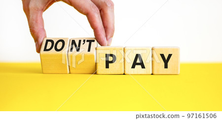 Do not pay symbol. Concept words do not pay on cubes. Businessman hand. Beautiful yellow table white background. Business, financial crisis and do not pay concept. Copy space. Do not pay symbol. Concept words do not pay on cubes. Businessman hand. Beautiful yellow table white background. Business, financial crisis and do not pay concept. Copy space. 97161506