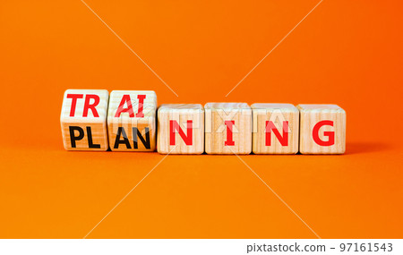 Training and planning symbol. Concept word Training and Planning on wooden cubes. Beautiful orange table orange background. Business training and planning concept. Copy space. 97161543