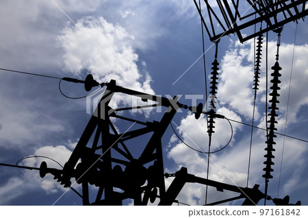 Electricity pylon (high voltage power line), black contour,  on the background of the cloudy sky 97161842
