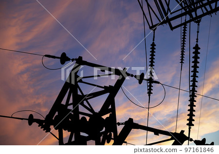 Electricity pylon (high voltage power line), black contour,  against the background of a romantic evening sky 97161846