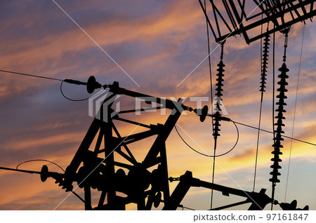 Electricity pylon (high voltage power line), black contour, against the background of a romantic evening sky Electricity pylon (high voltage power line), black contour, against the background of a romantic evening sky 97161847
