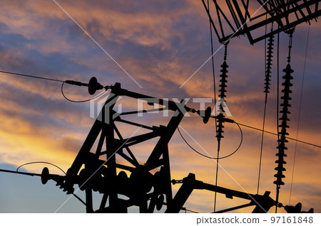 Electricity pylon (high voltage power line), black contour,  against the background of a romantic evening sky 97161848