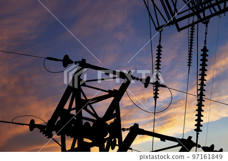 Electricity pylon (high voltage power line), black contour,  against the background of a romantic evening sky 97161849