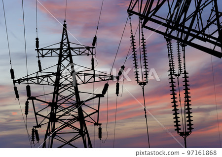 Electricity pylon (high voltage power line), black contour,  against the background of a romantic evening sky 97161868