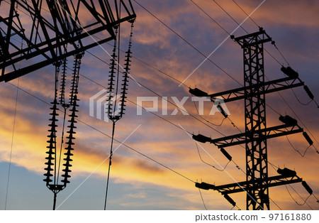 Electricity pylon (high voltage power line), black contour,  against the background of a romantic evening sky 97161880