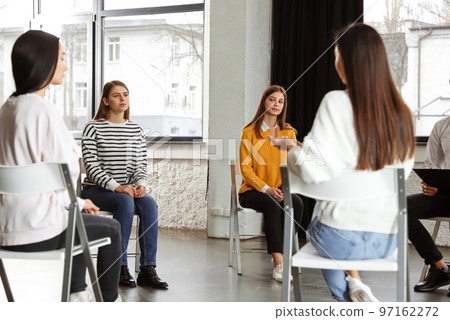 Psychotherapist working with patients in group therapy session indoors Psychotherapist working with patients in group therapy session indoors 97162272