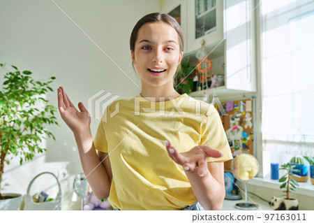 Smiling positive teenage girl looking at the camera 97163011