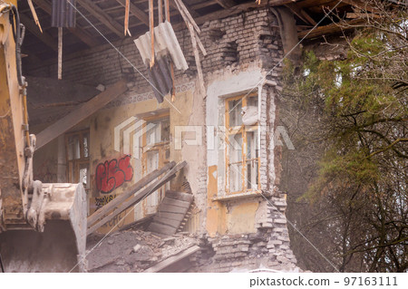 Demolition of an old brick building with an excavator bucket Demolition of an old brick building with an excavator bucket 97163111