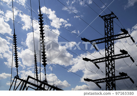 Electricity pylon (high voltage power line), black contour,  on the background of the cloudy sky 97163380