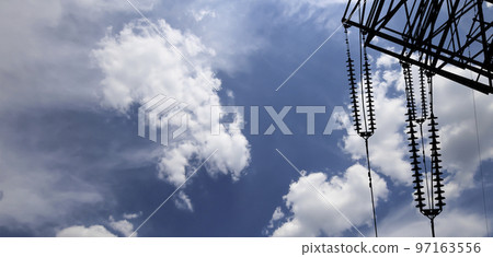 Electricity pylon (high voltage power line), black contour,  on the background of the cloudy sky 97163556