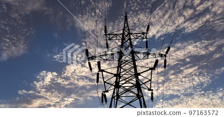 Electricity pylon (high voltage power line), black contour, against the background of a romantic evening sky Electricity pylon (high voltage power line), black contour, against the background of a romantic evening sky 97163572