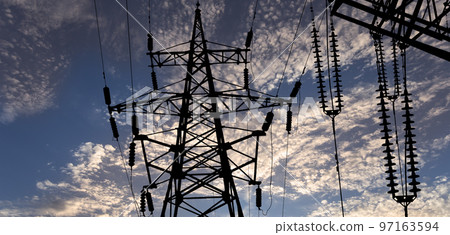 Electricity pylon (high voltage power line), black contour,  against the background of a romantic evening sky 97163594