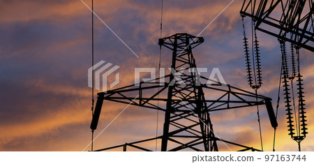 Electricity pylon (high voltage power line), black contour,  against the background of a romantic evening sky 97163744
