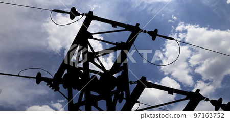 Electricity pylon (high voltage power line), black contour,  on the background of the cloudy sky 97163752