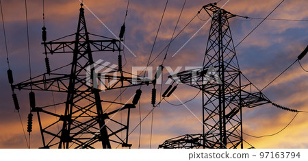 Electricity pylon (high voltage power line), black contour,  against the background of a romantic evening sky 97163794