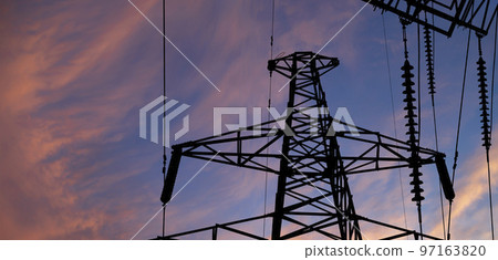 Electricity pylon (high voltage power line), black contour,  against the background of a romantic evening sky 97163820