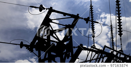 Electricity pylon (high voltage power line), black contour,  on the background of the cloudy sky 97163874