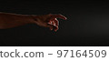 hand reaches for the light on a black background 97164509