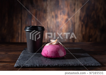 Coffee in a black glass with a lid. A glass of coffee and a pink cake. Strong coffee and sweets. Coffee in a black glass with a lid. A glass of coffee and a pink cake. Strong coffee and sweets. 97165531