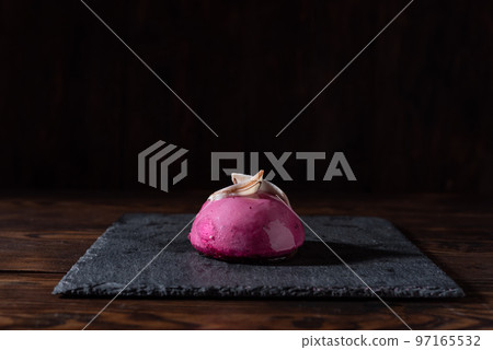 Sweet pink cake. Pastry. Semicircular red cake with chocolate and berries. One cake on the table. Sweet pink cake. Pastry. Semicircular red cake with chocolate and berries. One cake on the table. 97165532