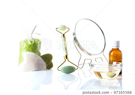 Mirror and face and skin care products. Stones and rollers for skin massage. Mirror, oil and bath salts. Mirror and face and skin care products. Stones and rollers for skin massage. Mirror, oil and bath salts. 97165566