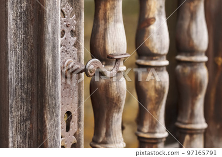 Ancient door with ornate doorknob and keyhole. Vintage historical entrance of an antique building Ancient door with ornate doorknob and keyhole. Vintage historical entrance of an antique building 97165791