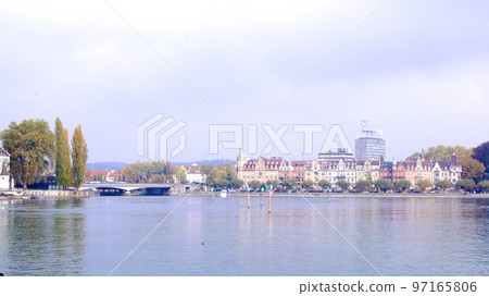 KONSTANZ, GERMANY - 14 OCT 2015: Lake Constance promenade with a bridge in the background KONSTANZ, GERMANY - 14 OCT 2015: Lake Constance promenade with a bridge in the background 97165806