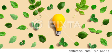 Yellow light bulb with green leaves Yellow light bulb with green leaves 97166563