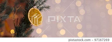 Banner close-Up Of Dry Orange Slice Hanging On Christmas Tree Banner close-Up Of Dry Orange Slice Hanging On Christmas Tree 97167269