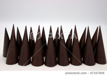 Elongated chocolates on white background Elongated chocolates on white background 97167806