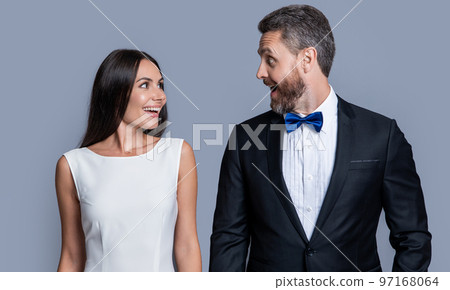 surprised couple in formal tuxedo. studio shot of formal tuxedo couple. elegant couple 97168064