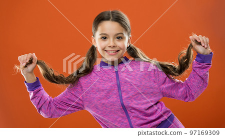 Small girl child. Hairdresser for kids. Happy little girl with long hair. childrens day. Portrait of happy little child. Kid fashion sportswear. childhood happiness. Family. Capturing bright moments Small girl child. Hairdresser for kids. Happy little girl with long hair. childrens day. Portrait of happy little child. Kid fashion sportswear. childhood happiness. Family. Capturing bright moments 97169309