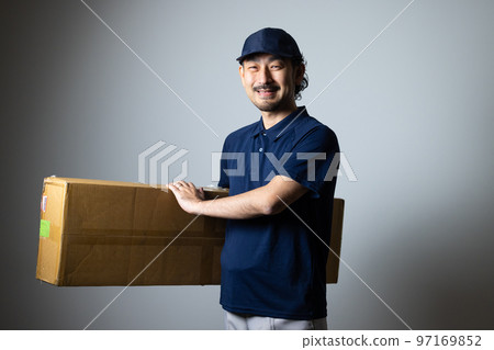 bearded delivery man with large cardboard 97169852