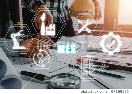 MES - Manufacturing Execution System concept, Construction team worker working in office with mes icon on virtual screen. MES - Manufacturing Execution System concept, Construction team worker working in office with mes icon on virtual screen. 97169985