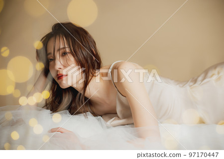 A woman in a beige dress 97170447
