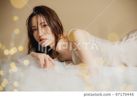 A woman in a beige dress 97170448