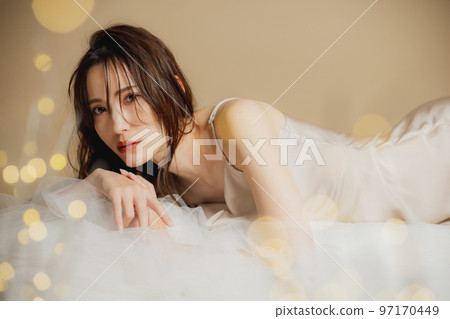 A woman in a beige dress 97170449