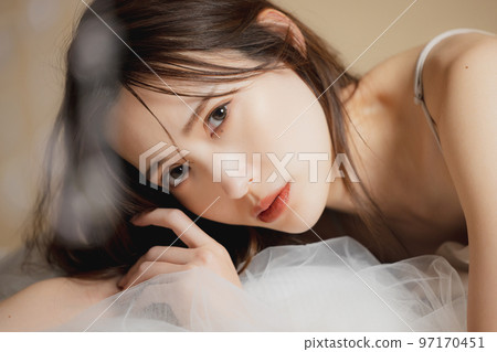 A woman in a beige dress 97170451