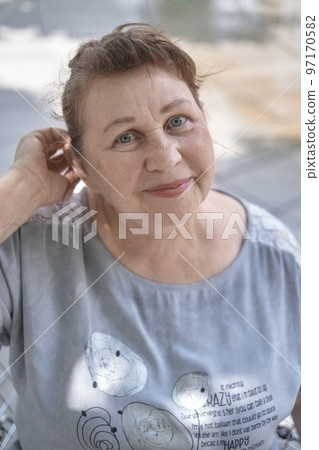 Portrait of a friendly elderly woman 97170582