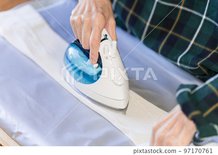 Senior woman doing ironing 97170761