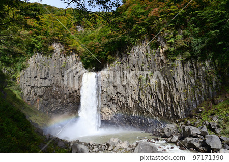 Naena Falls and the basin of the waterfall with a dynamic flow when the autumn leaves have begun 97171390